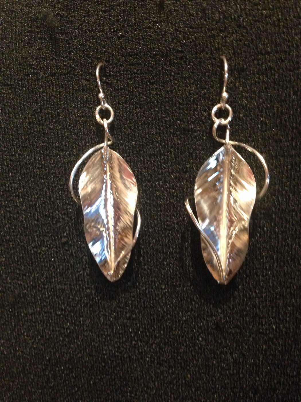 Hand-forged leaf earrings on black
