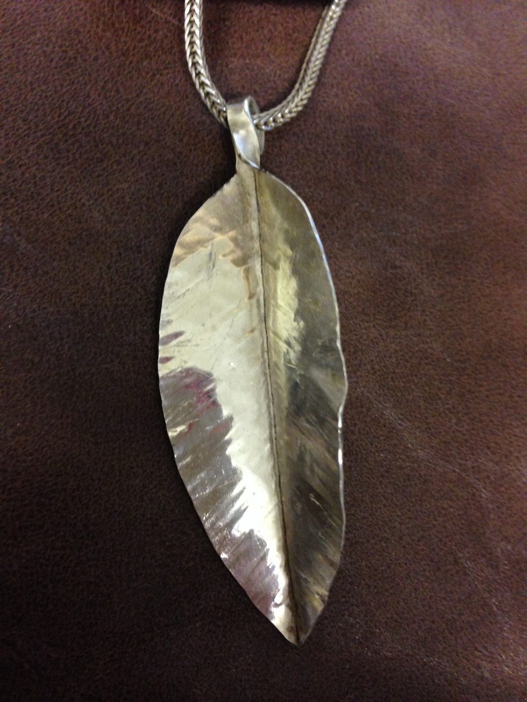 Folded leaf pendant on a woven chain